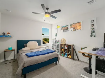 a bedroom with bed and a chandelier