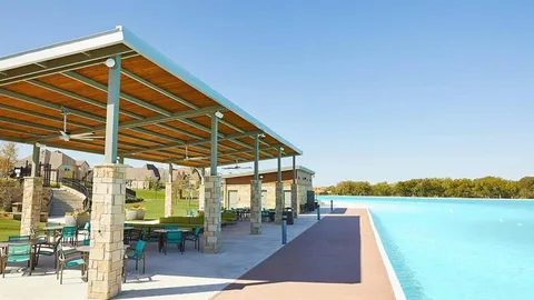 a view of a patio with a table and chairs under an umbrella