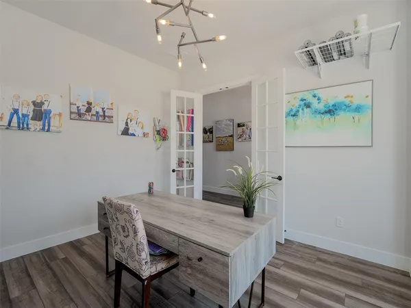 a view of a dining room with furniture wooden floor and a chandelier