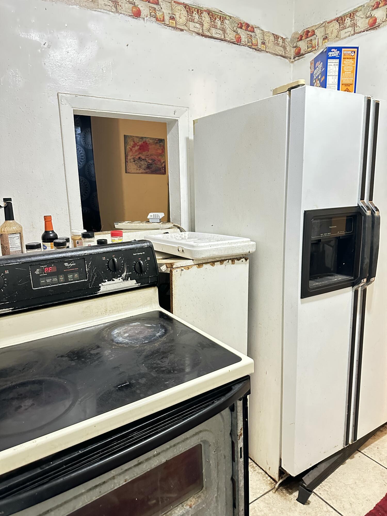 116 Southwest 11th Avenue Delray Beach, FL 33444 - Photo 9 of 10 a kitchen with a stove and a refrigerator