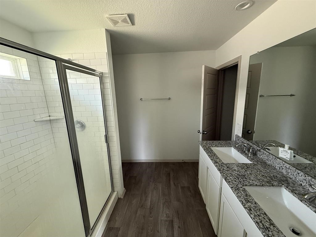 6710 Riplee Street Beaumont, TX 77708 - Photo 12 of 15 a bathroom with a granite countertop sink a mirror and shower