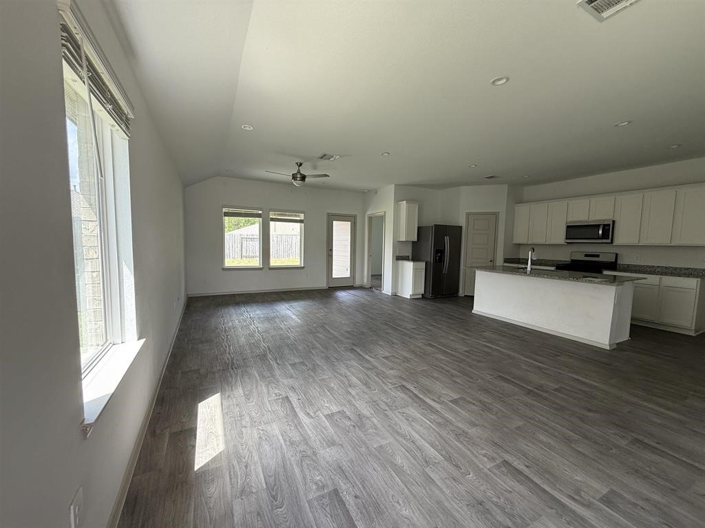 6710 Riplee Street Beaumont, TX 77708 - Photo 4 of 15 a view of a big room with wooden floor and windows