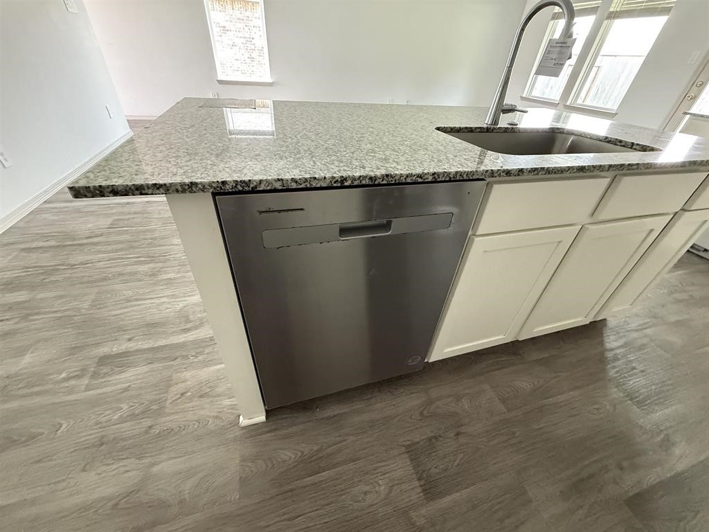 6710 Riplee Street Beaumont, TX 77708 - Photo 7 of 15 a kitchen with granite countertop a sink and a granite counter tops