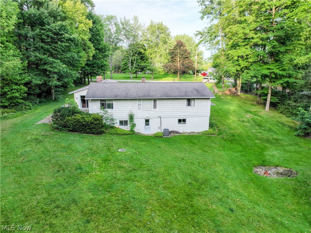 11430 Ferry Road Chesterland, OH 44026 - Photo 35 of 38 Rear view of house with a lawn