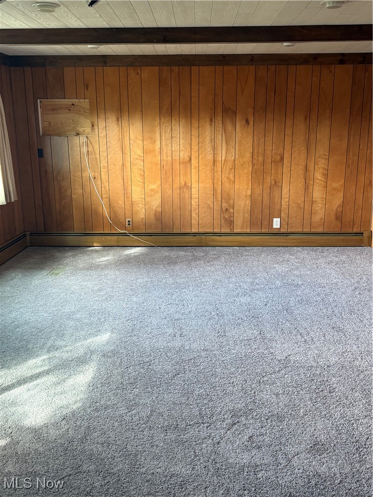 1284 Haverston Road Lyndhurst, OH 44124 - Photo 18 of 43 Carpeted spare room with beamed ceiling, wood walls, and a baseboard radiator