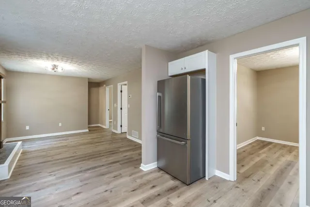 a kitchen with a refrigerator and a sink