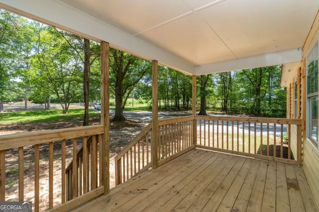 a view of a porch with wooden floor and outdoor space