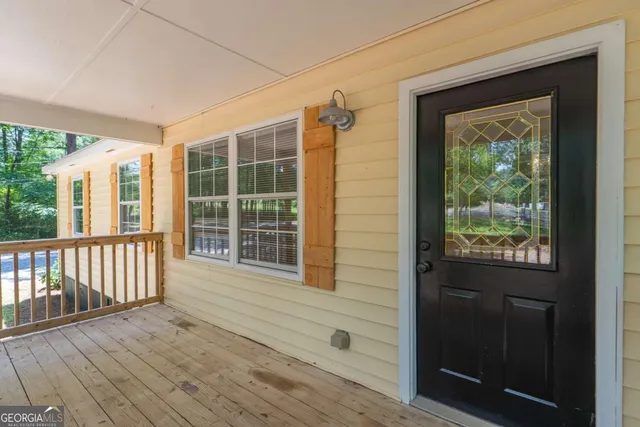 a view of front door and porch with wooden floor