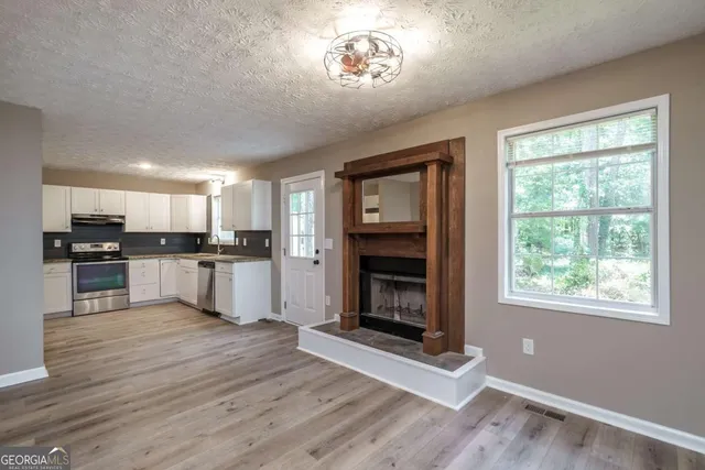 a view of kitchen with sink and microwave