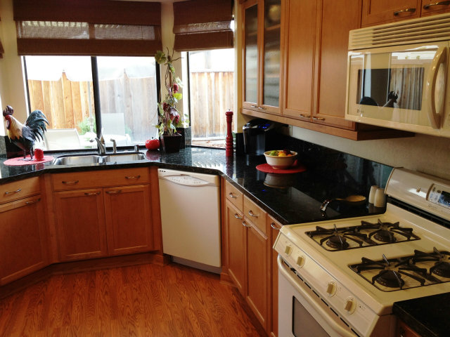 277 Michigan Road Milpitas, CA 95035 - Photo 3 of 25 a kitchen with a stove a sink and wooden floor