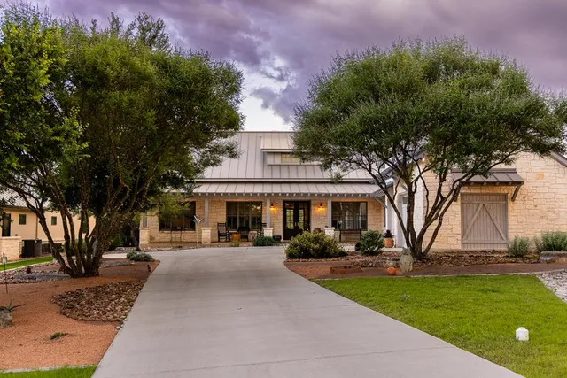 a view of a yard with plants and a fountain