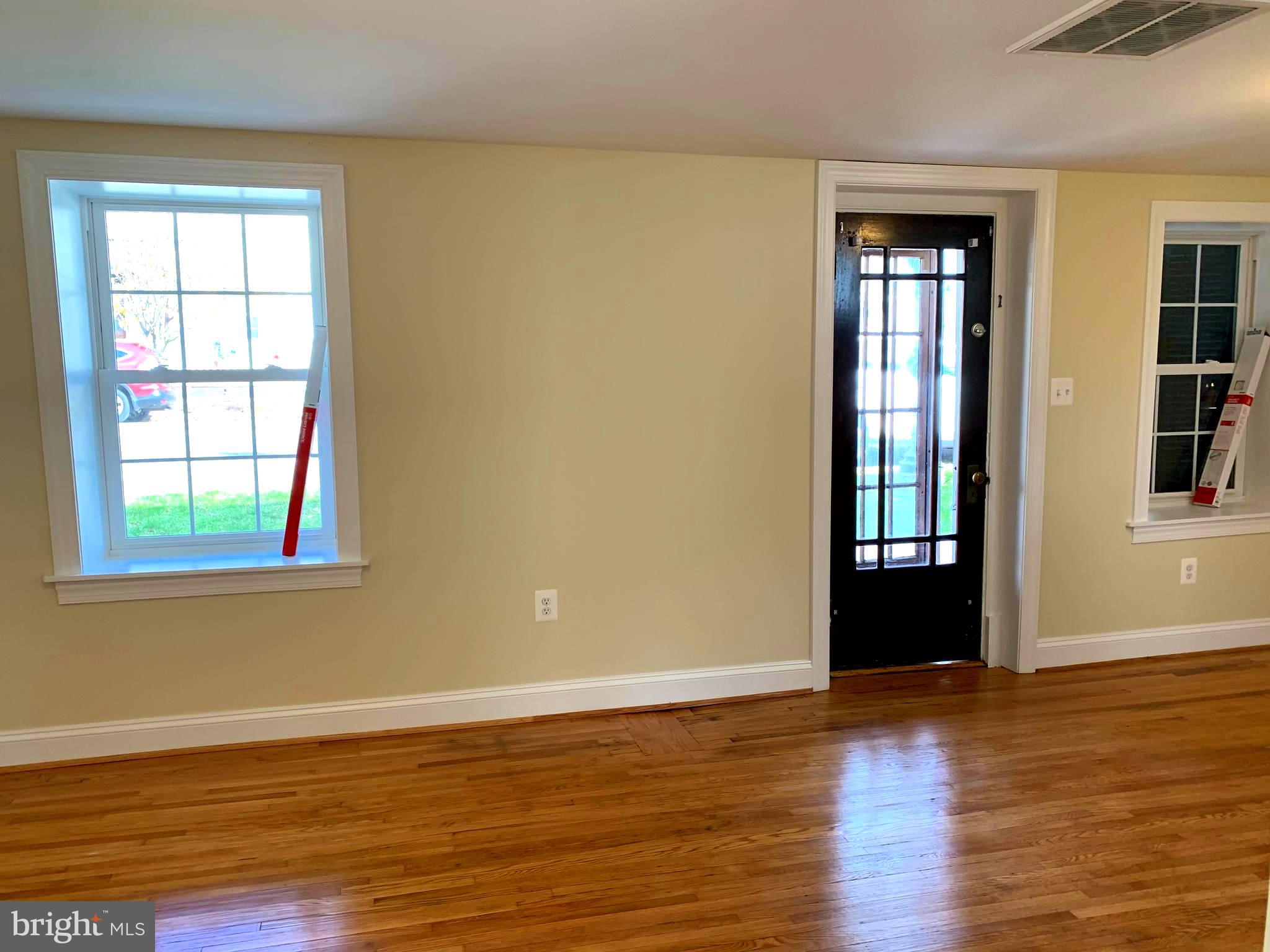 116 North Main Street Boonsboro, MD 21713 - Photo 12 of 44 an empty room with wooden floor and windows