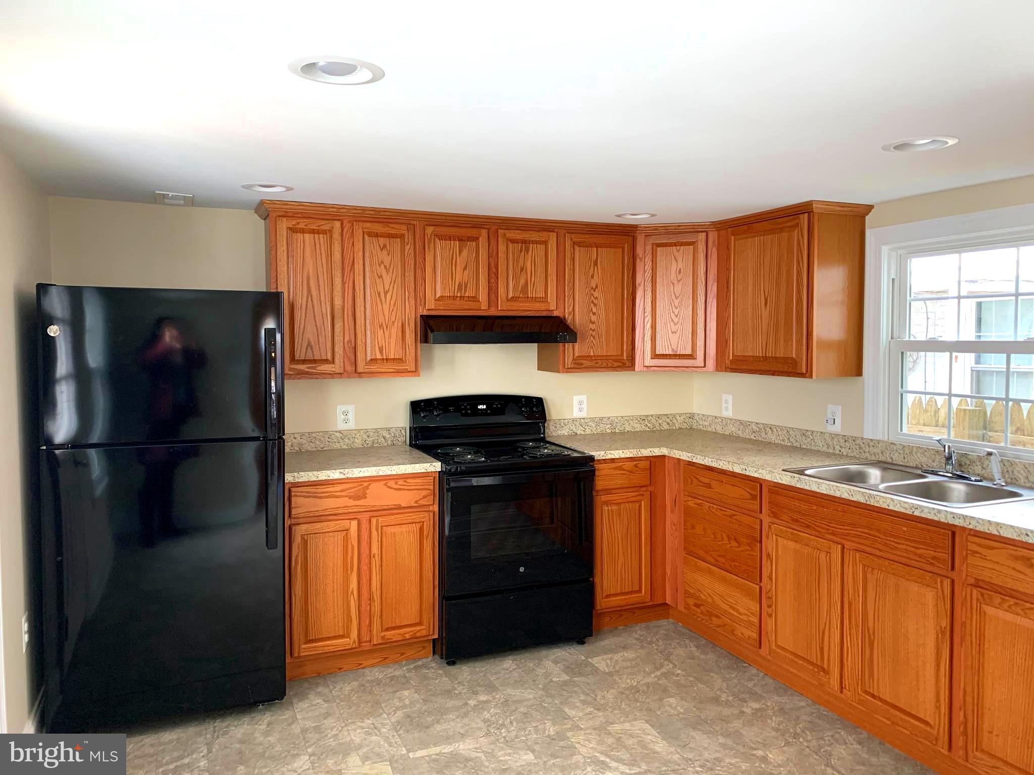 116 North Main Street Boonsboro, MD 21713 - Photo 15 of 44 a kitchen with a refrigerator and a sink
