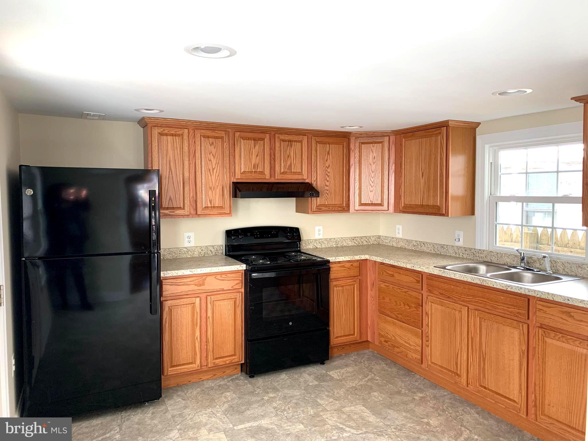 116 North Main Street Boonsboro, MD 21713 - Photo 17 of 44 a kitchen with a refrigerator and a sink