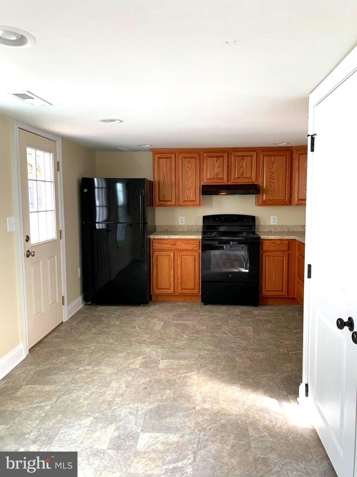 116 North Main Street Boonsboro, MD 21713 - Photo 18 of 44 a kitchen with granite countertop a refrigerator and a stove