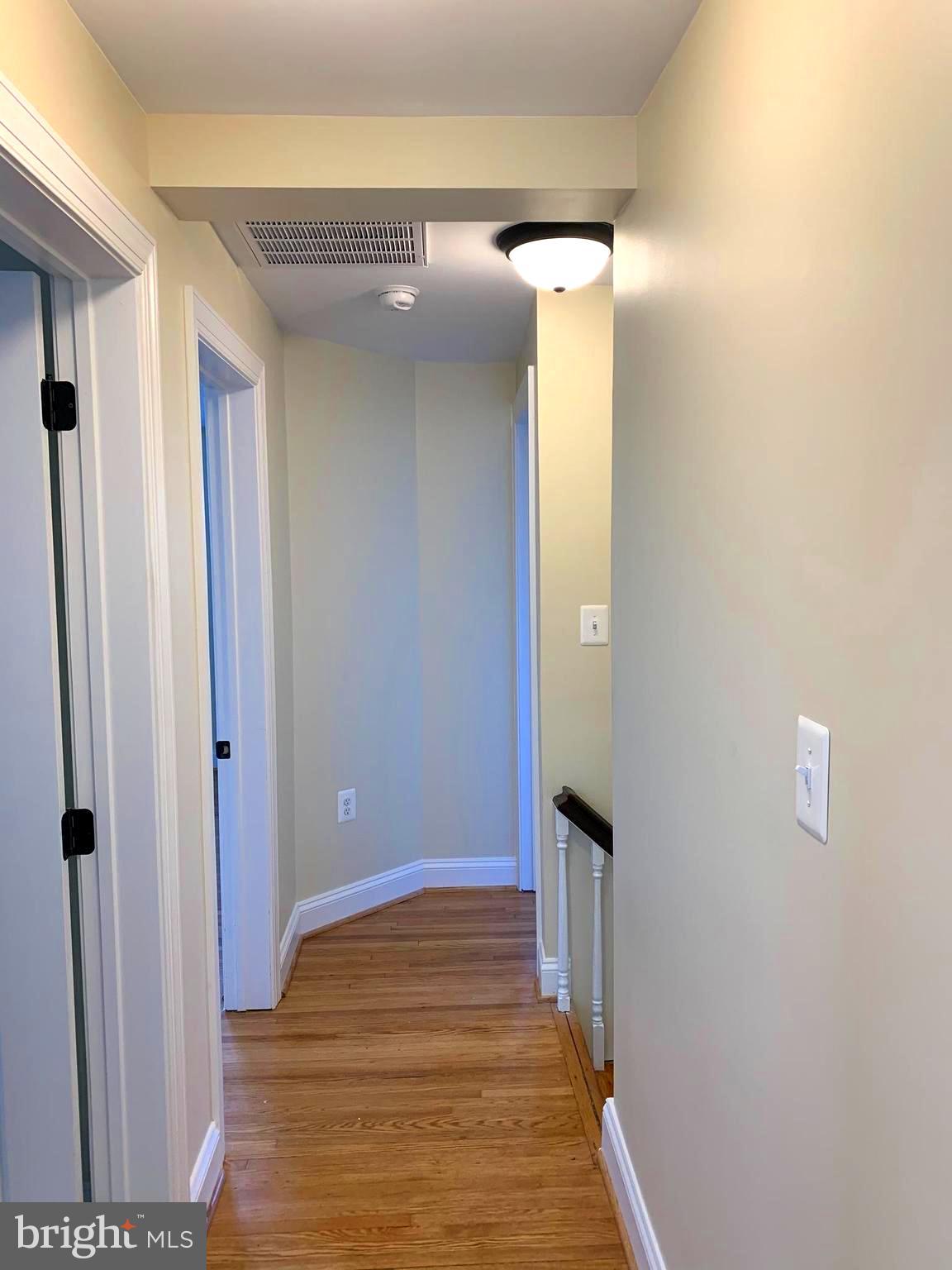 116 North Main Street Boonsboro, MD 21713 - Photo 20 of 44 a view of a hallway with wooden floor and staircase