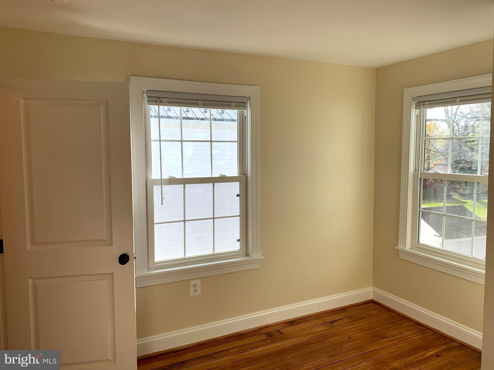 116 North Main Street Boonsboro, MD 21713 - Photo 22 of 44 a view of an empty room with wooden floor and a window