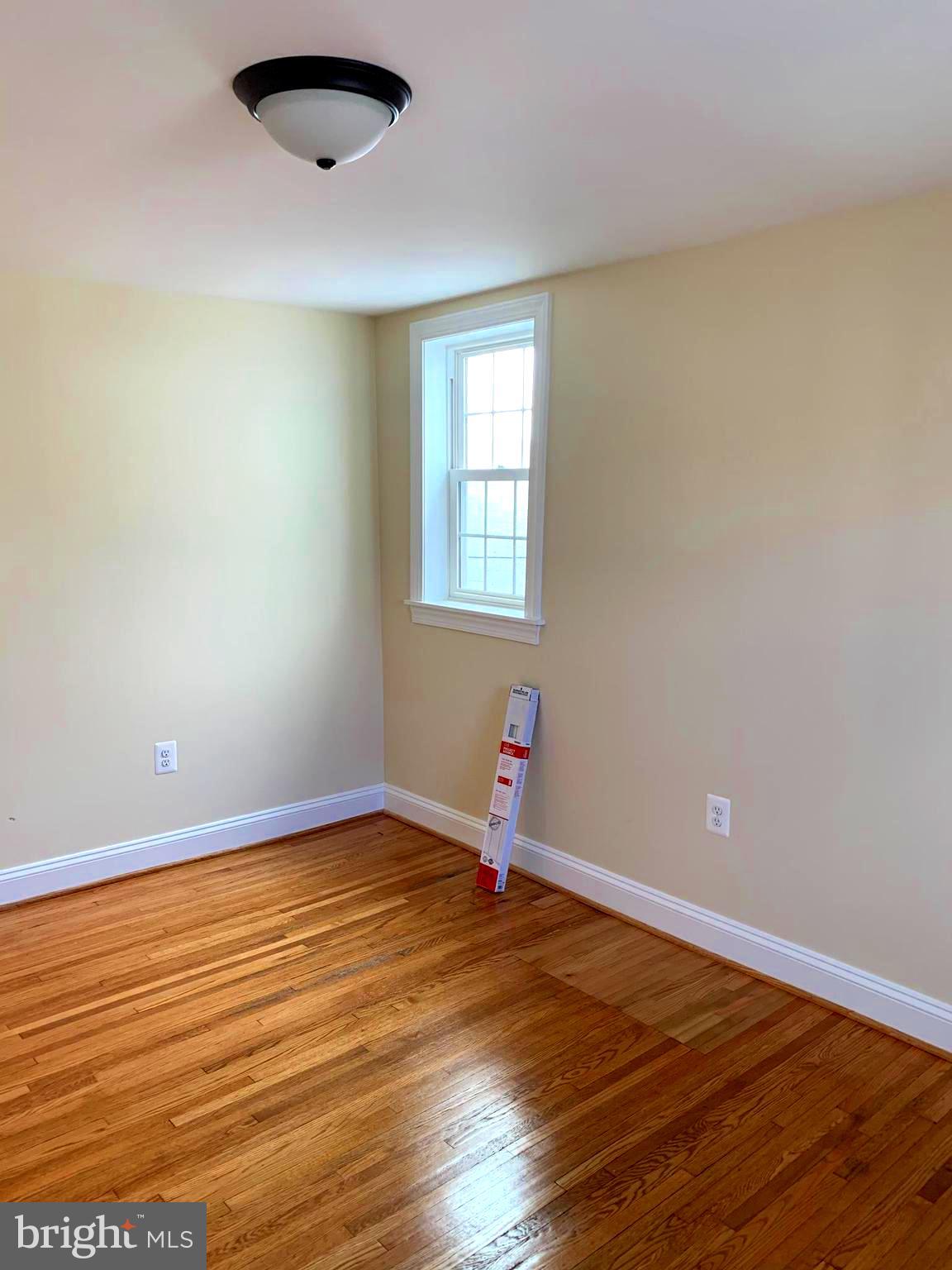 116 North Main Street Boonsboro, MD 21713 - Photo 33 of 44 an empty room with wooden floor and windows