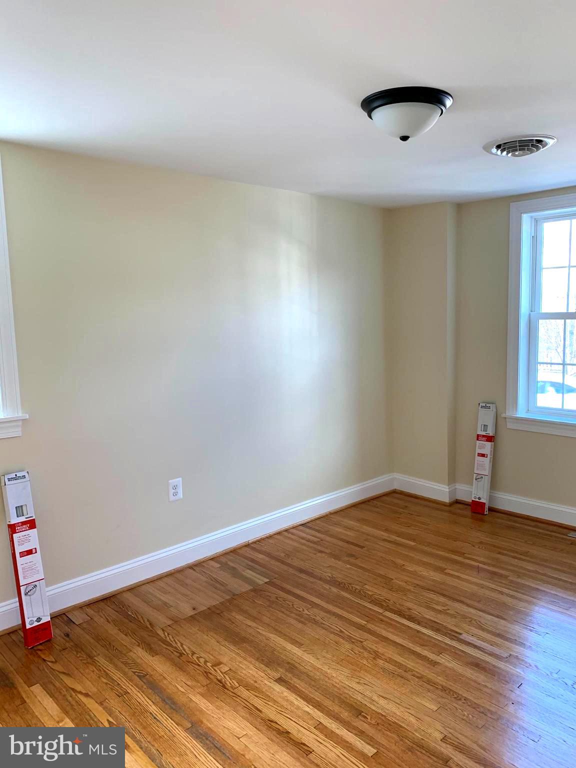 116 North Main Street Boonsboro, MD 21713 - Photo 37 of 44 an empty room with wooden floor and windows