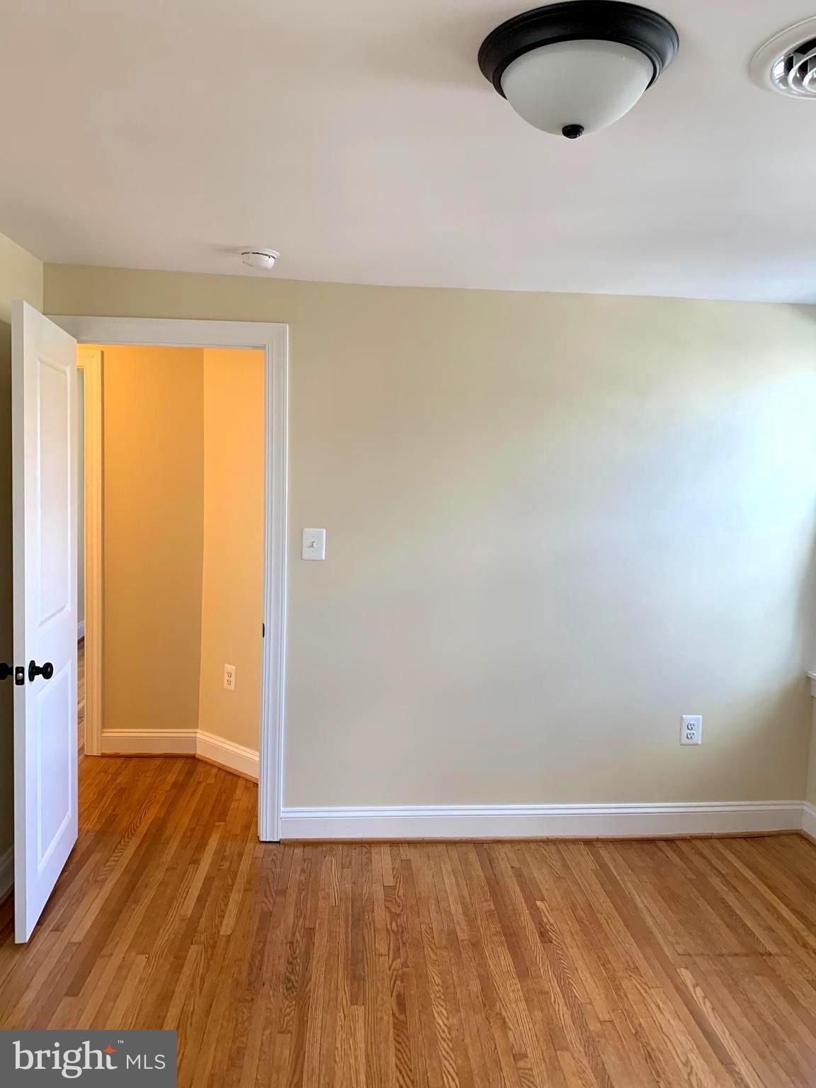 116 North Main Street Boonsboro, MD 21713 - Photo 39 of 44 an empty room with wooden floor and windows