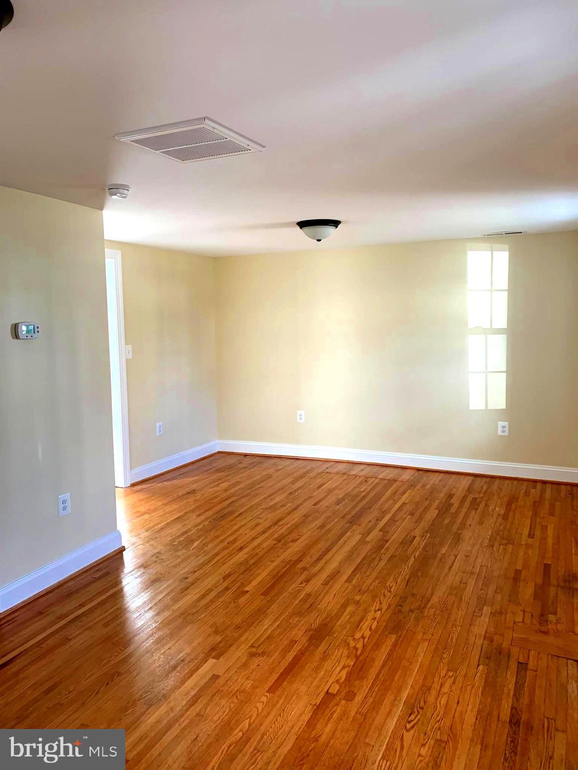 116 North Main Street Boonsboro, MD 21713 - Photo 4 of 44 an empty room with wooden floor and windows