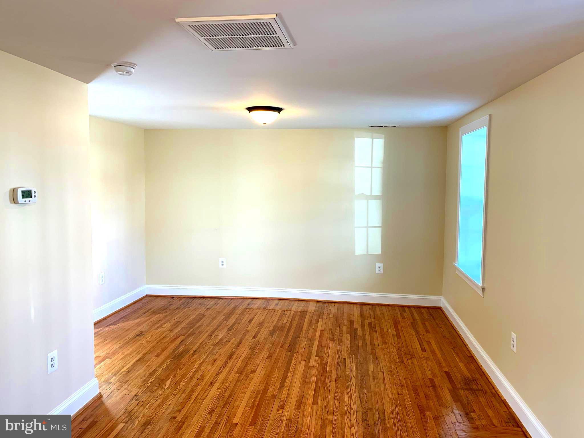 116 North Main Street Boonsboro, MD 21713 - Photo 8 of 44 an empty room with wooden floor and windows