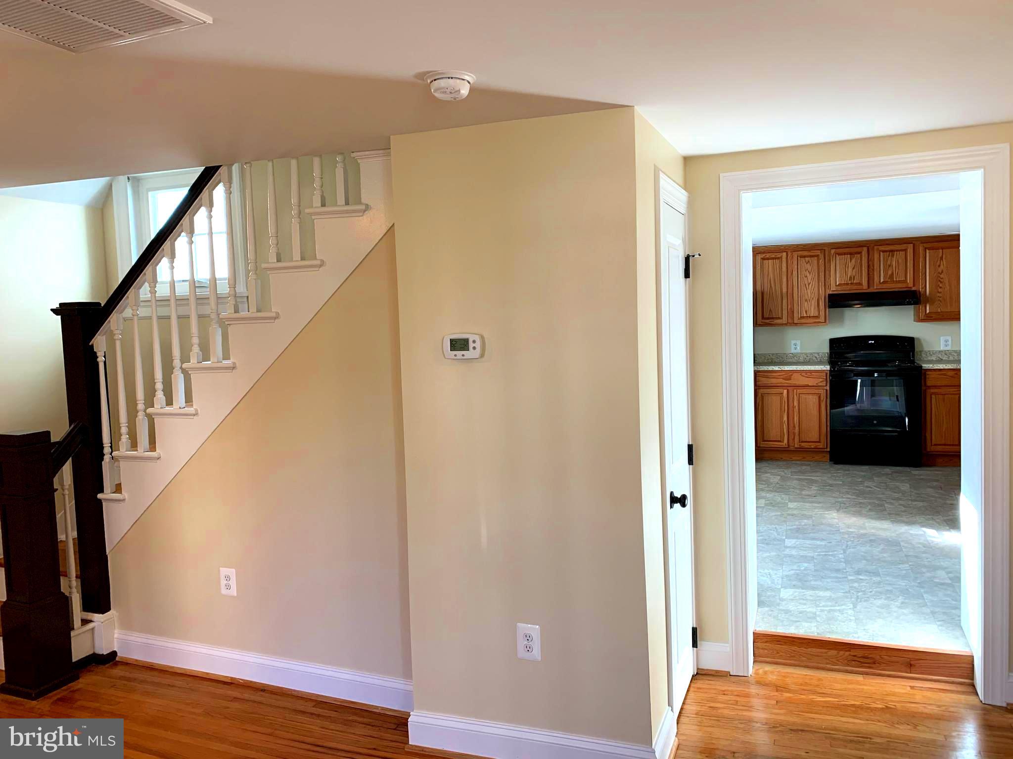 116 North Main Street Boonsboro, MD 21713 - Photo 9 of 44 a view of a hallway with wooden floor and staircase