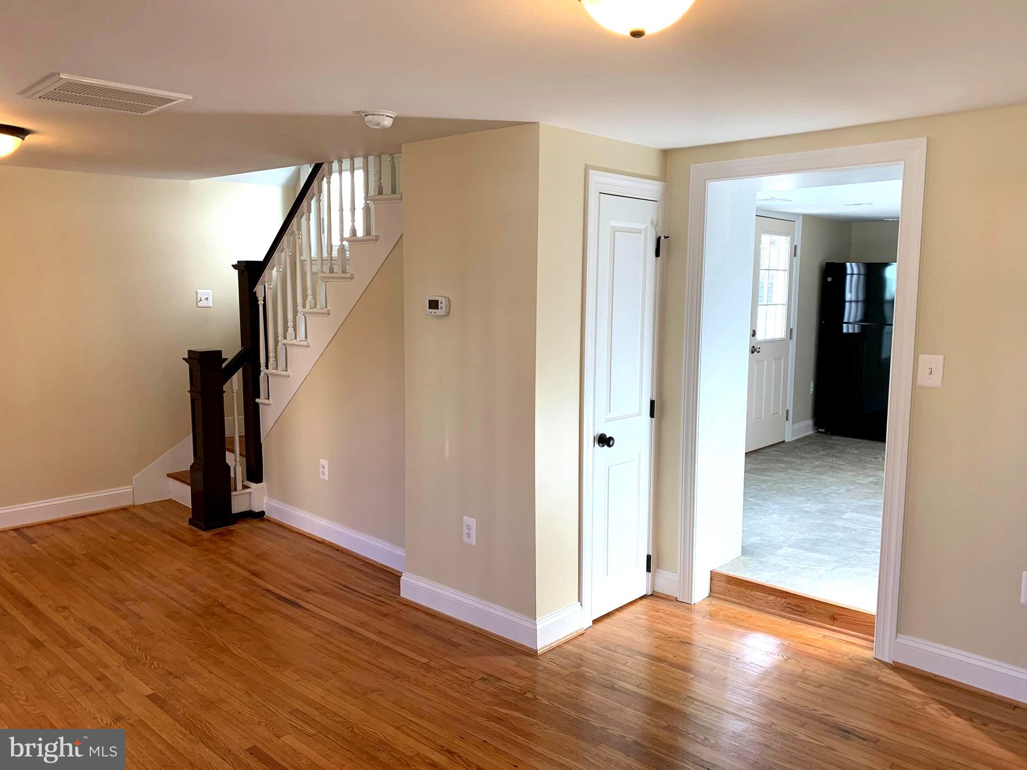 116 North Main Street Boonsboro, MD 21713 - Photo 10 of 44 a view of an empty room with wooden floor and stairs