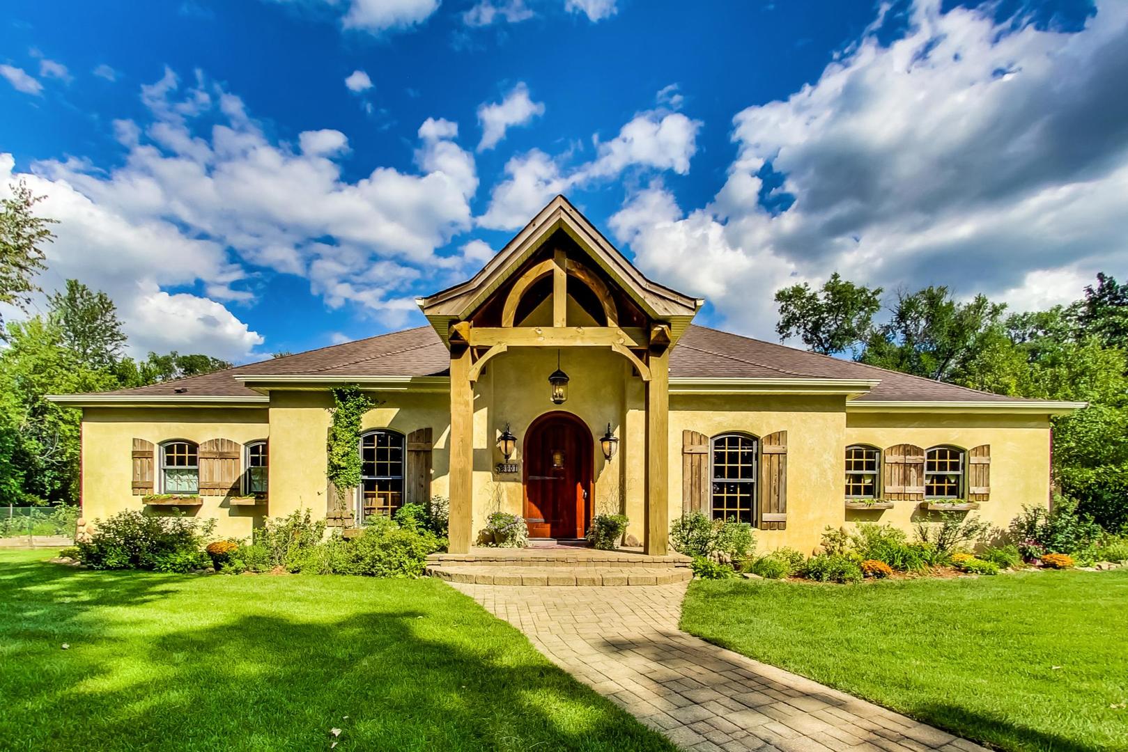 8901 Maple Avenue Burr Ridge, IL 60527 - Photo 1 of 68 a front view of a house with a garden