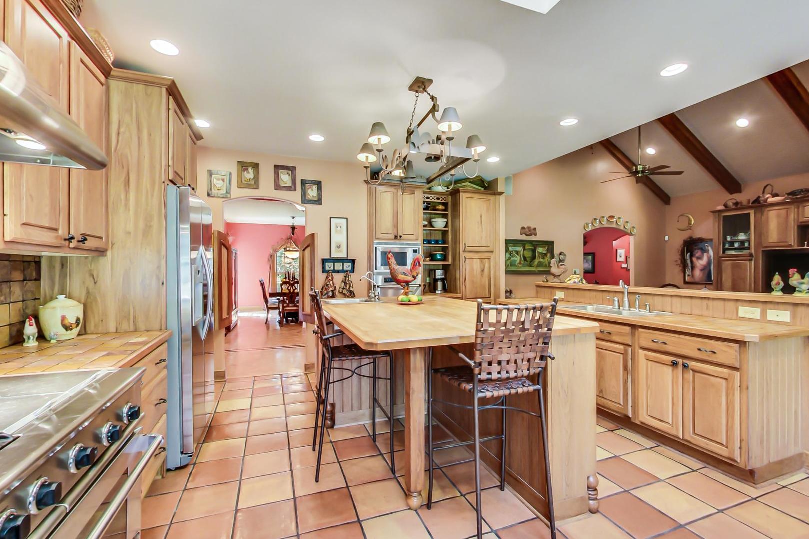 8901 Maple Avenue Burr Ridge, IL 60527 - Photo 11 of 68 a large kitchen with a table and chairs