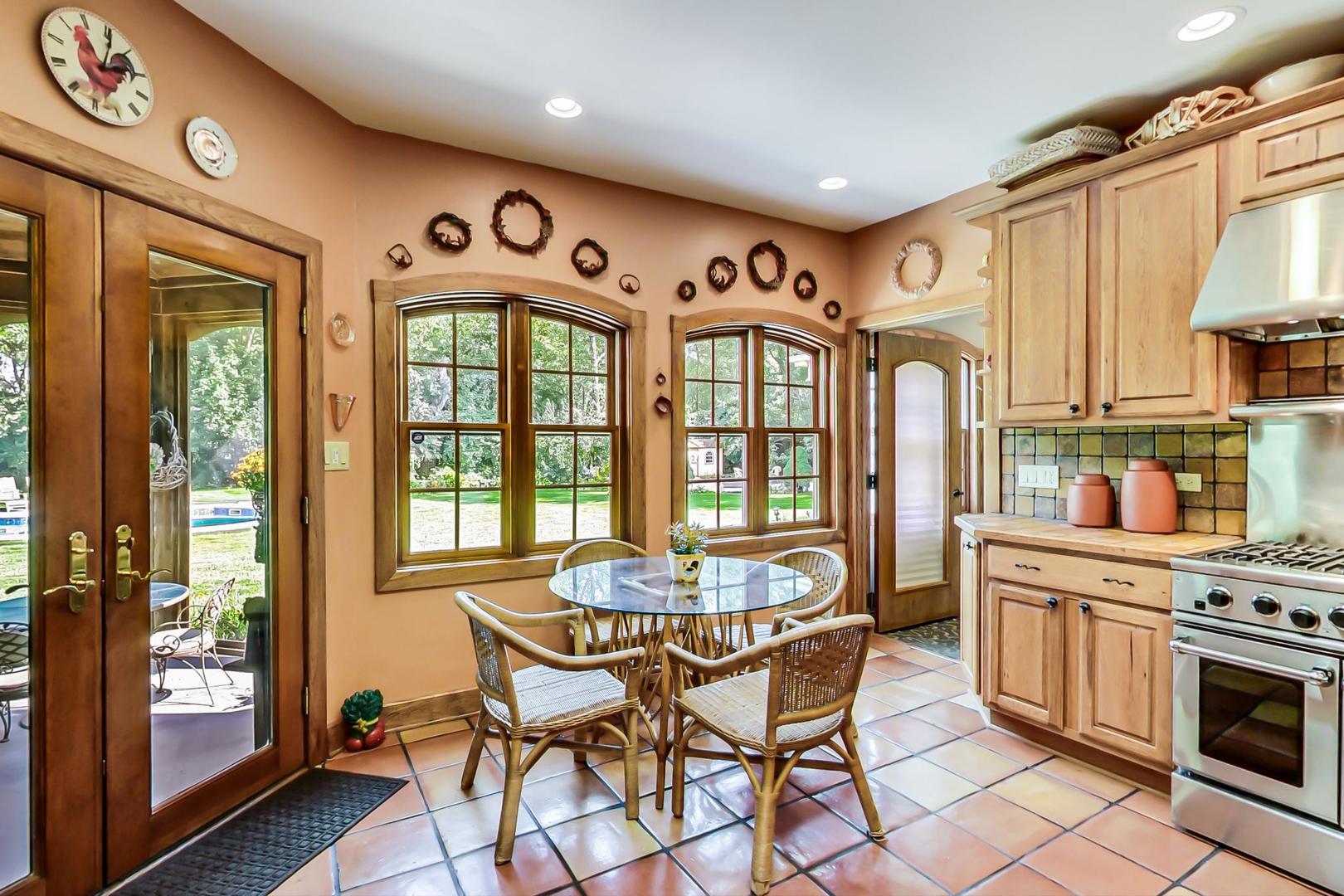 8901 Maple Avenue Burr Ridge, IL 60527 - Photo 13 of 68 a dining room with furniture a chandelier and wooden floor