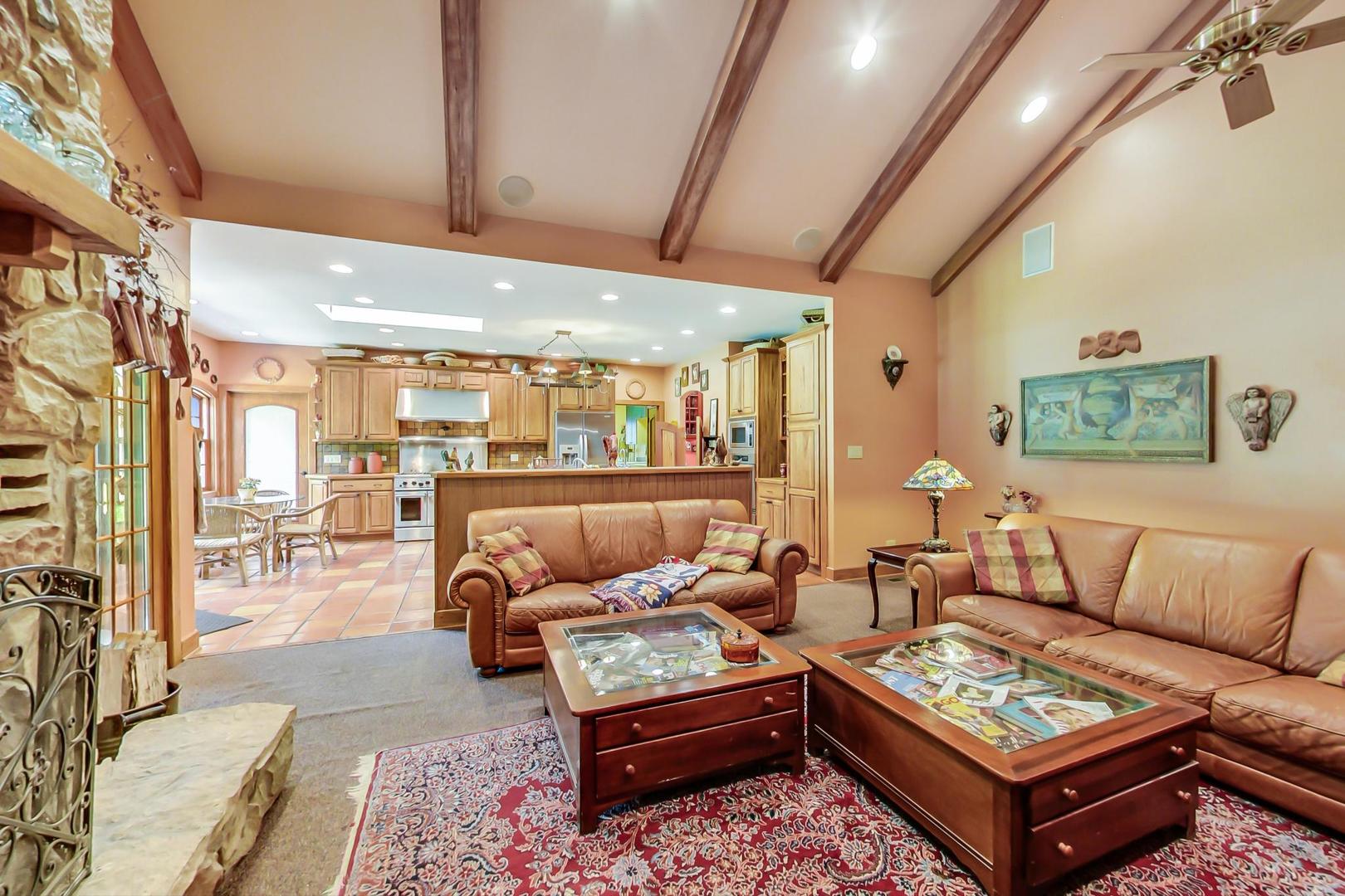 8901 Maple Avenue Burr Ridge, IL 60527 - Photo 16 of 68 a living room with furniture a rug and a chandelier