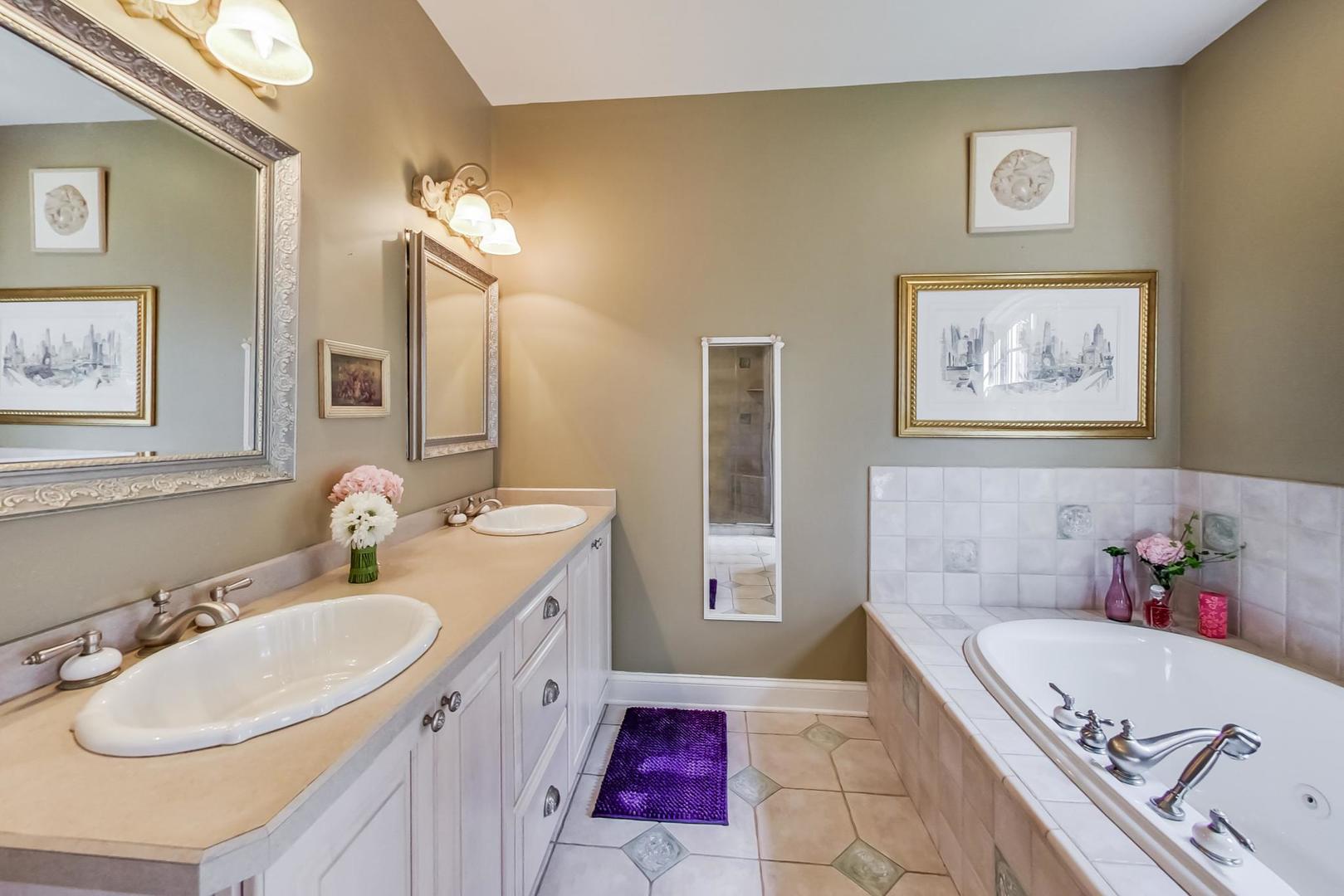 8901 Maple Avenue Burr Ridge, IL 60527 - Photo 24 of 68 a bathroom with a tub sink and mirror