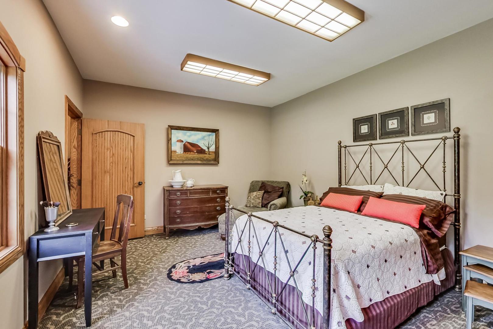8901 Maple Avenue Burr Ridge, IL 60527 - Photo 30 of 68 a bedroom with a bed and a table in it
