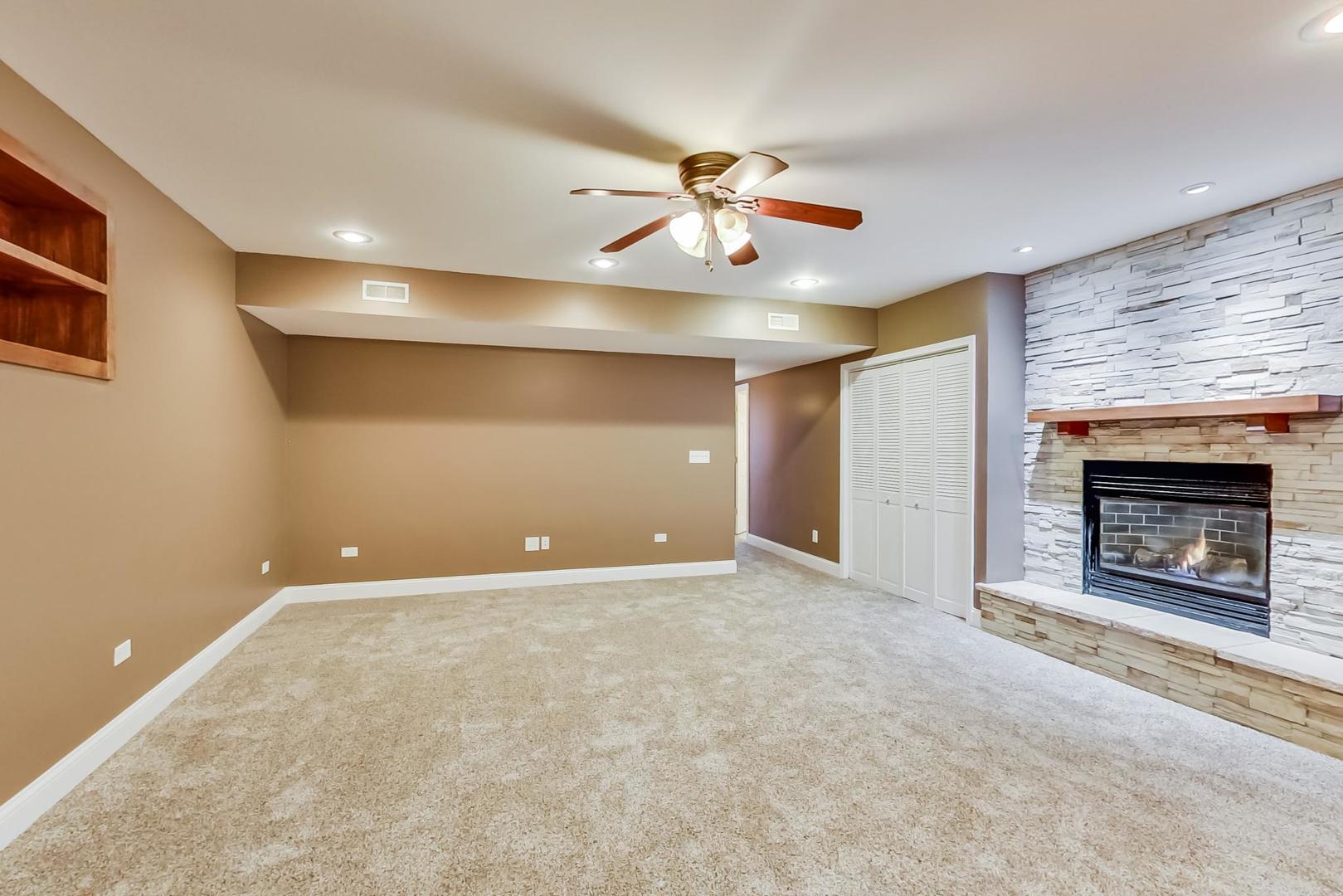 8901 Maple Avenue Burr Ridge, IL 60527 - Photo 36 of 68 a view of an empty room with a fireplace