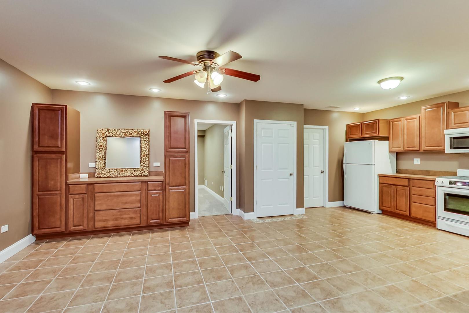 8901 Maple Avenue Burr Ridge, IL 60527 - Photo 41 of 68 a kitchen with stainless steel appliances kitchen island granite countertop a refrigerator and a stove top oven
