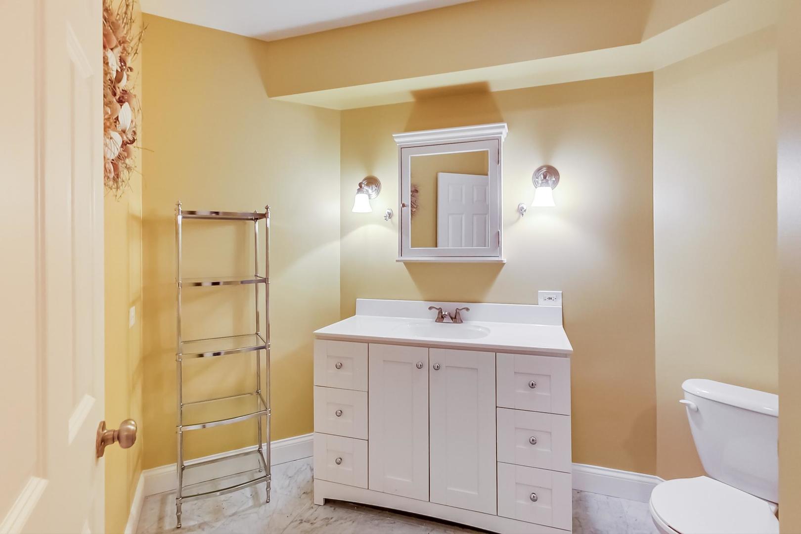 8901 Maple Avenue Burr Ridge, IL 60527 - Photo 49 of 68 a bathroom with a granite countertop sink toilet and shower