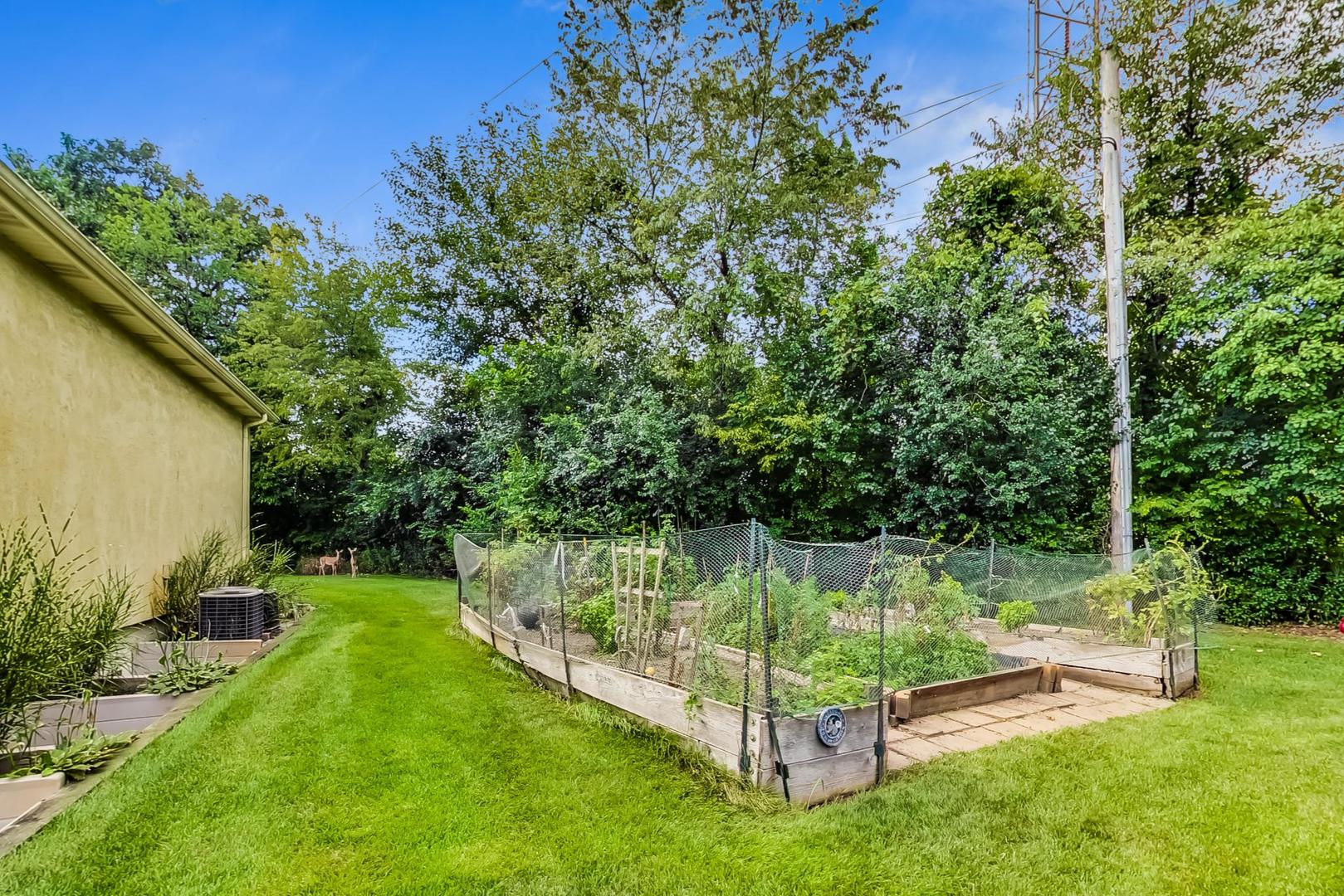 8901 Maple Avenue Burr Ridge, IL 60527 - Photo 62 of 68 a view of a garden with a bench