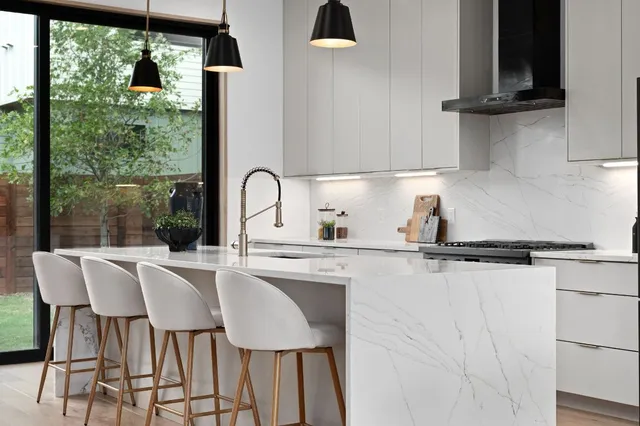a kitchen with a table chairs and window