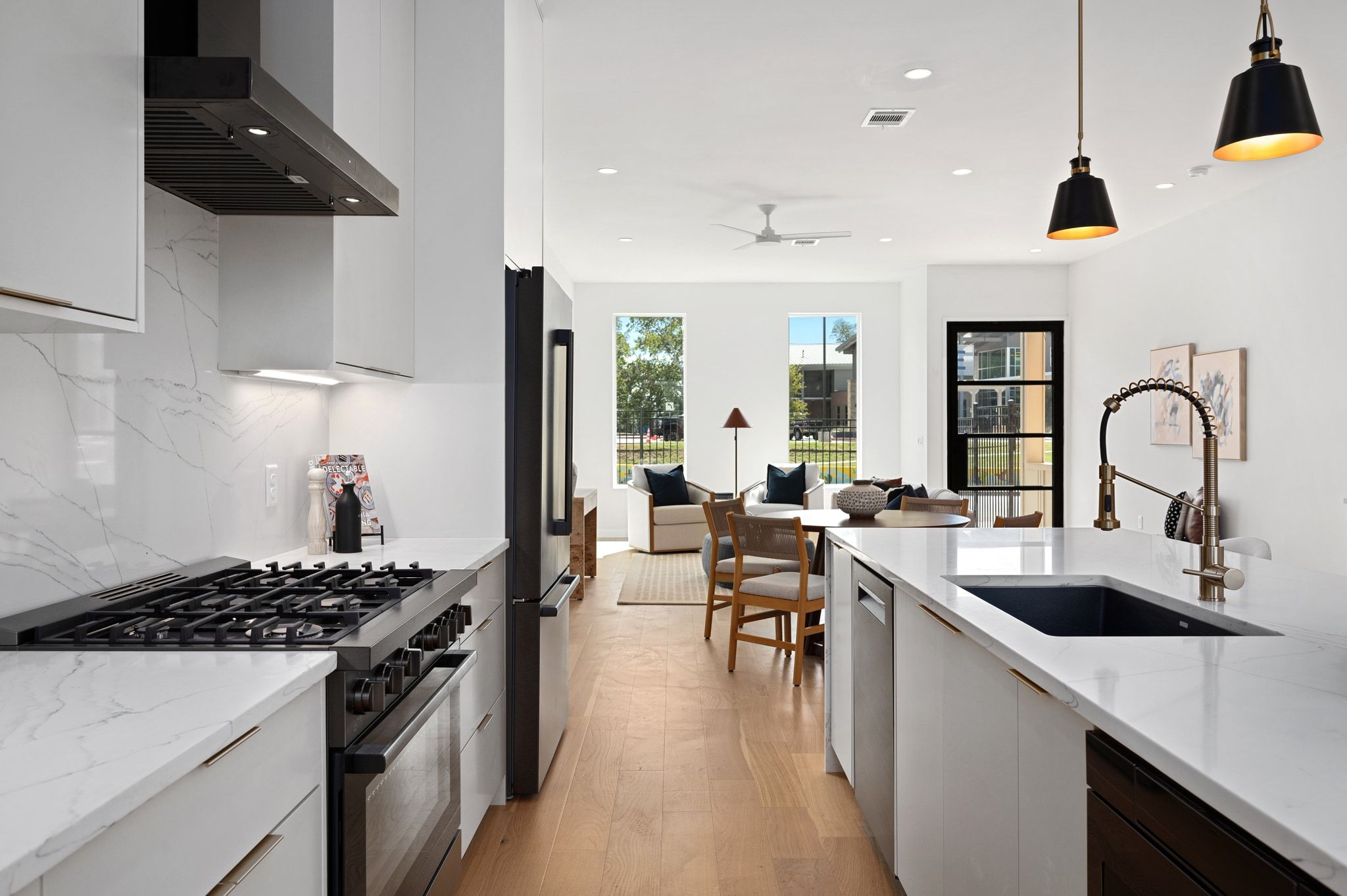 1104 1/2 Gunter Street Austin, TX 78702 - Photo 22 of 40 a kitchen with sink a stove and chairs