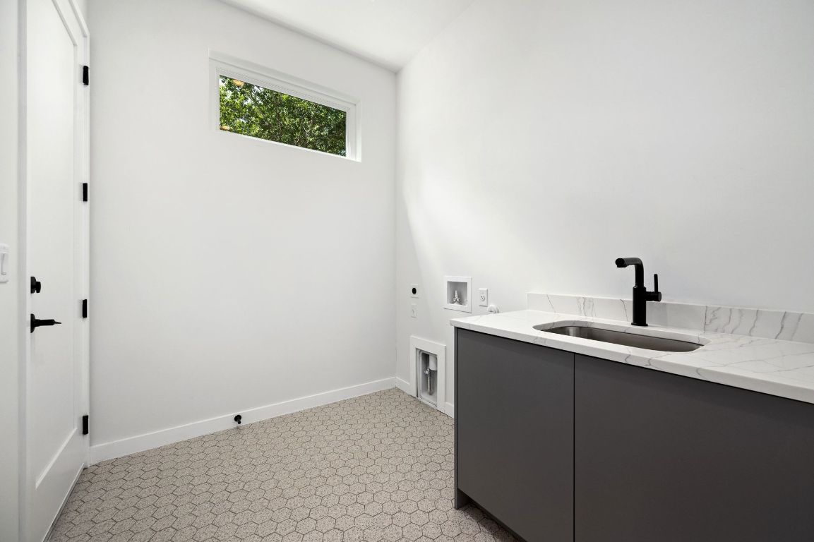 1104 Gunter Street, Unit 1/2 Austin, TX 78702 - Photo 24 of 40 a view of a bathroom with a sink and mirror
