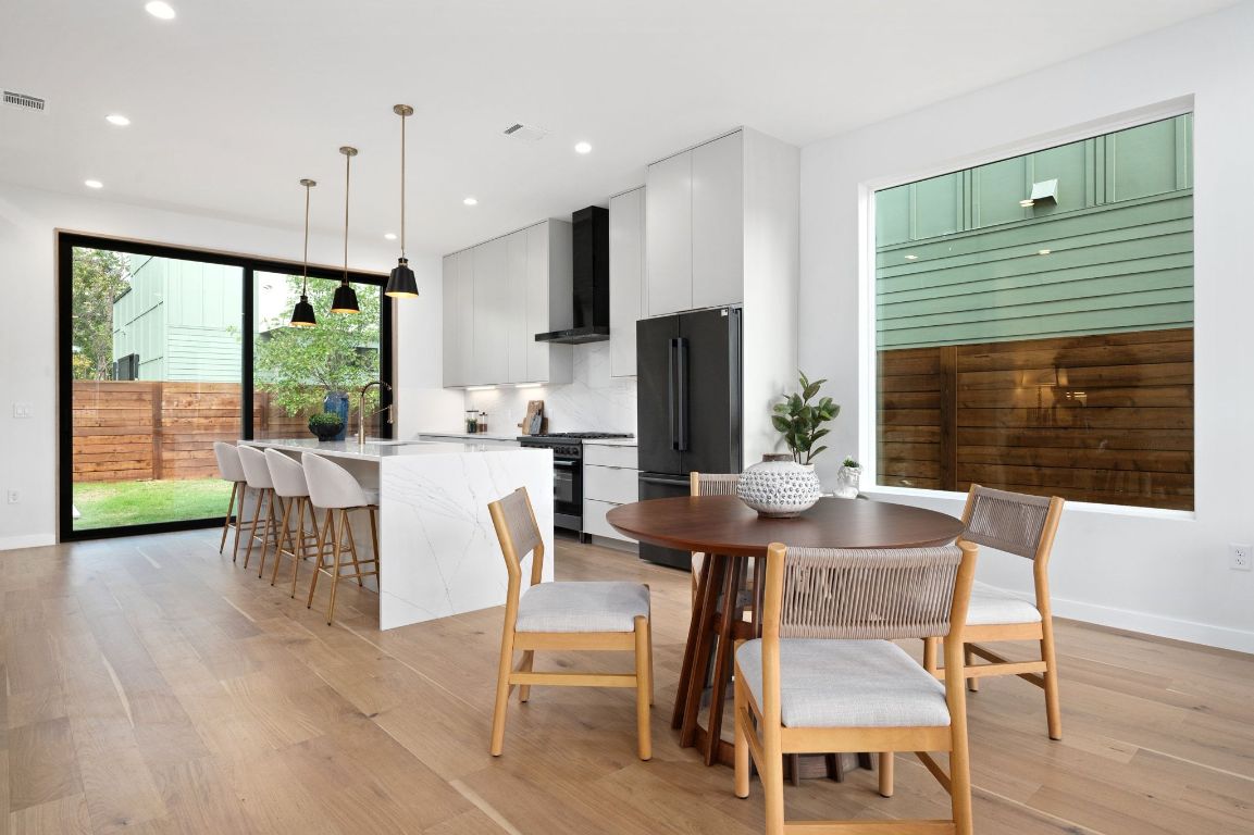 1104 Gunter Street, Unit 1/2 Austin, TX 78702 - Photo 3 of 40 a view of a dining room with furniture window and wooden floor
