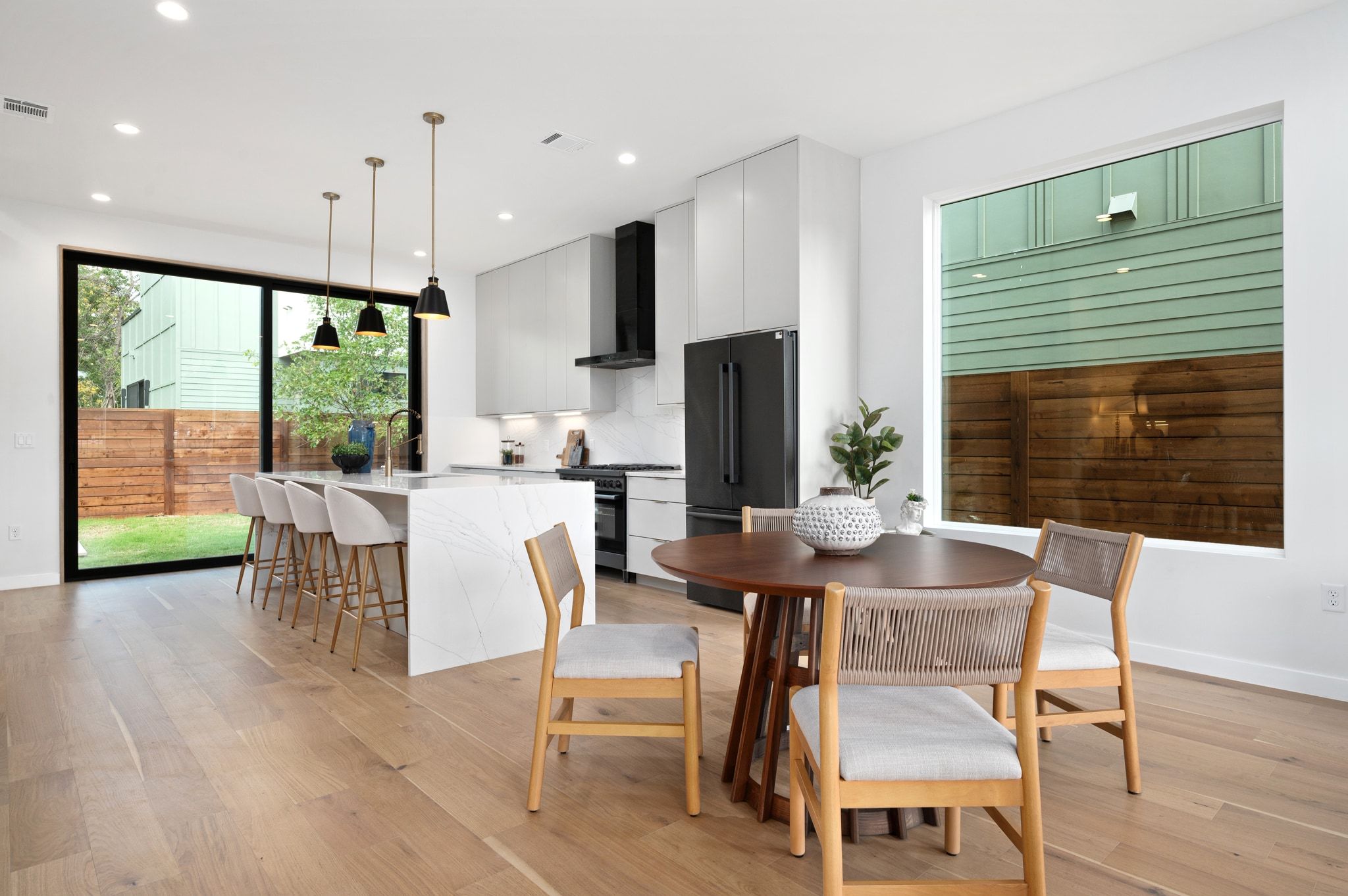 1104 1/2 Gunter Street Austin, TX 78702 - Photo 3 of 40 a view of a dining room with furniture window and wooden floor