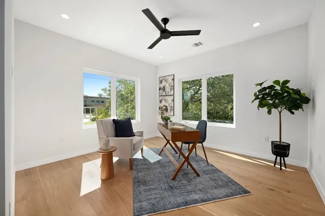 a living room with furniture a rug and a large window