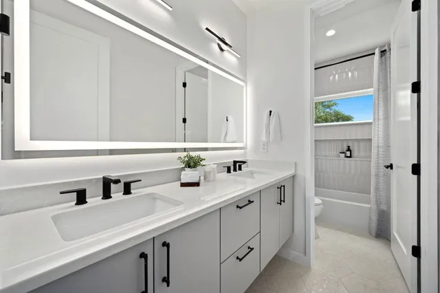 a bathroom with a double vanity sink mirror and double