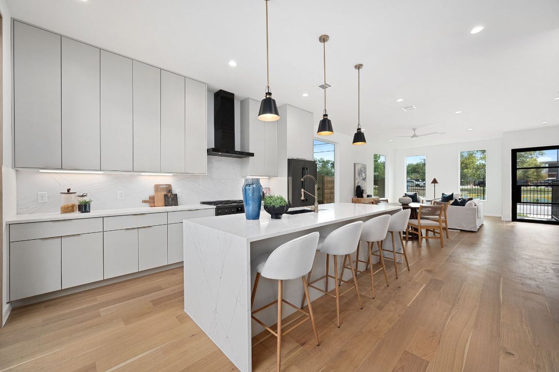 1104 Gunter Street, Unit 1/2 Austin, TX 78702 - Photo 5 of 40 a kitchen with appliances a sink a counter top space and a center island
