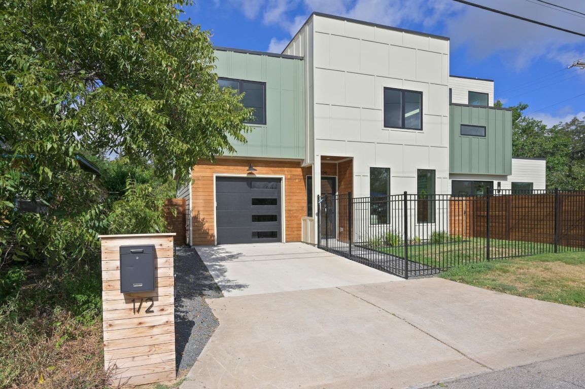 1104 Gunter Street, Unit 1/2 Austin, TX 78702 - Photo 8 of 40 a front view of a house with glass windows and plants