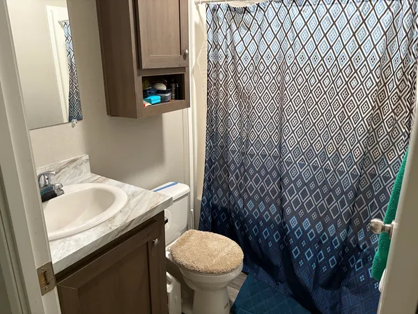 a bedroom with furniture and a flat screen tv
