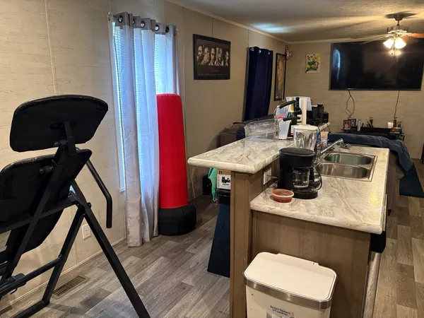 a kitchen with a sink a stove and a dining table