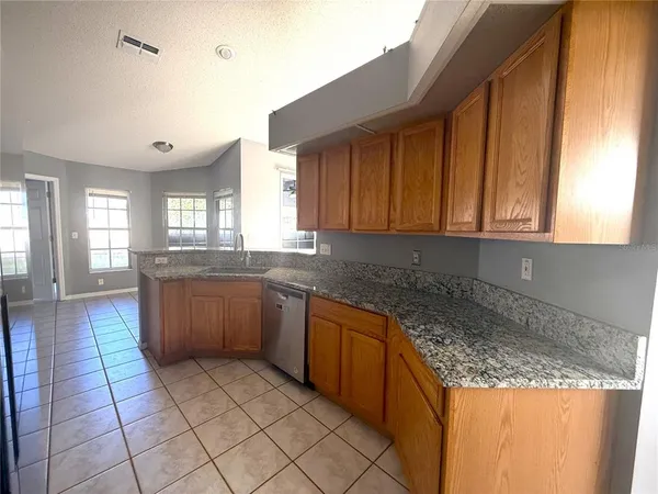 a kitchen with stainless steel appliances granite countertop a sink and cabinets